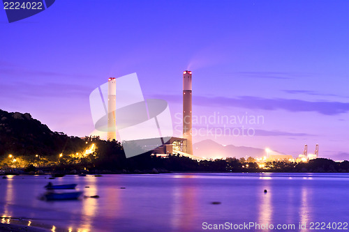 Image of Power plant along coast at sunset