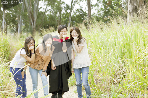 Image of Asian friends in graduation