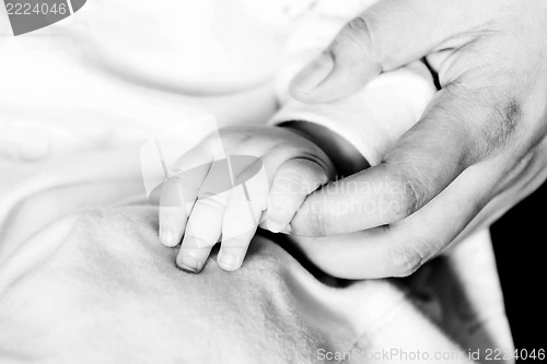 Image of Baby holding hands