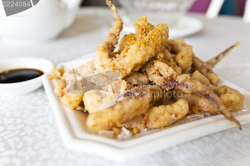 Image of Plate of fried calamari served with sauce