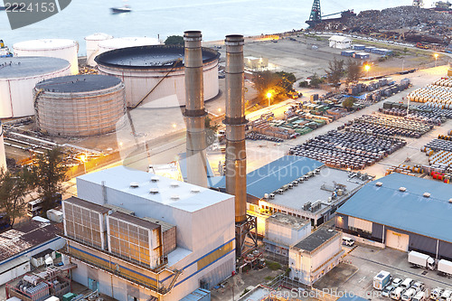 Image of Oil tank and chimney at night