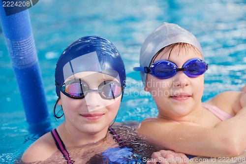 Image of happy children group  at swimming pool