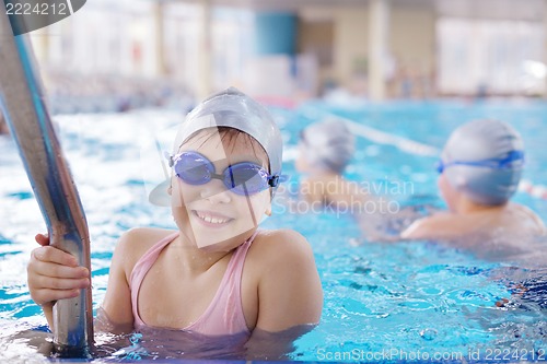 Image of happy children group  at swimming pool