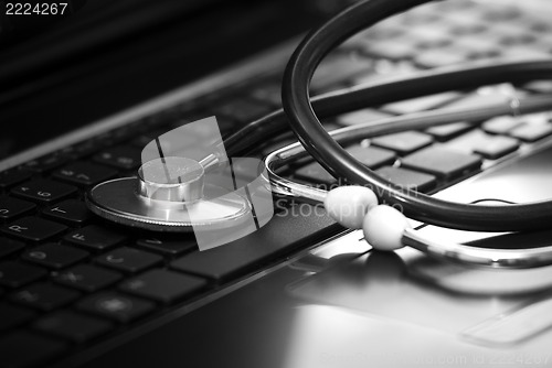 Image of Stethoscope lying down on an laptop