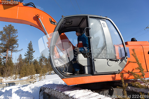 Image of Excavator with metal tracks running in the woods