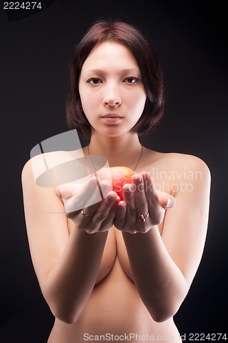 Image of Nude woman offers apple