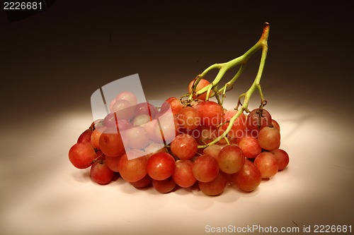 Image of red grapes in the dark night