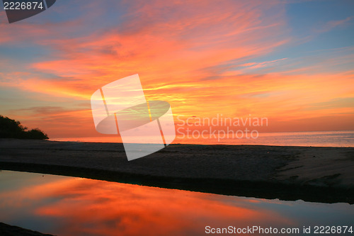 Image of Sunrise over the pacific ocean and the end of the lake with refl