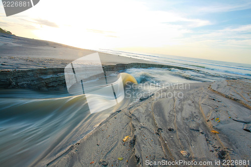 Image of sand beach and lake in the sunrise