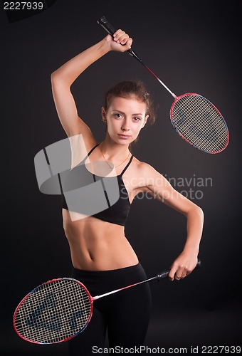 Image of Beautiful girl with a rackets in hands