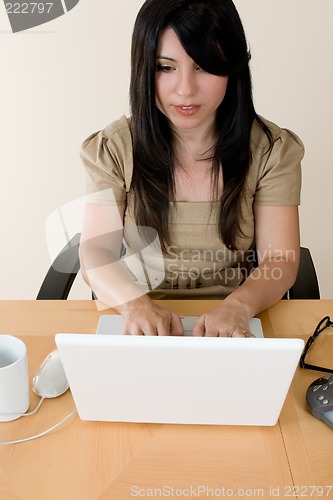 Image of Woman typing on a laptop