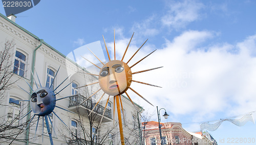 Image of march goes city street people carry sun figures 