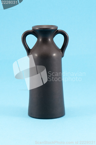 Image of old ceramic vase with two handle blue background 