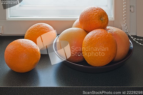 Image of Oranges on the windowsill.