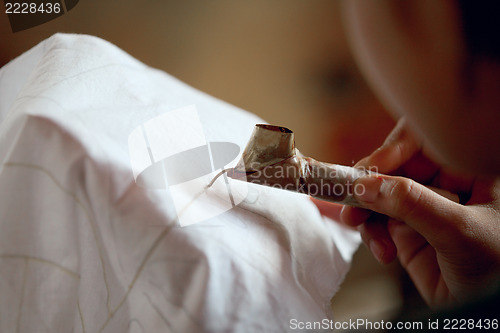 Image of Making batik process. Application of wax on fabric