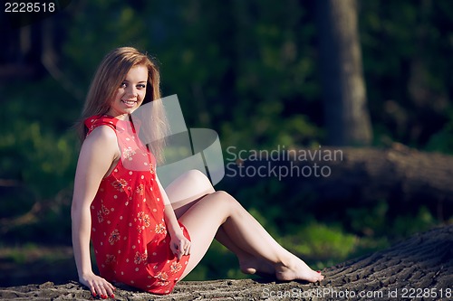 Image of Girl siting on a log