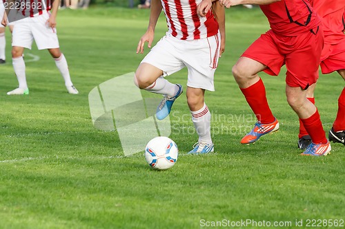 Image of Soccer player legs dribbling in a match