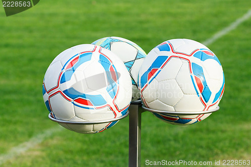 Image of three football bals on holders