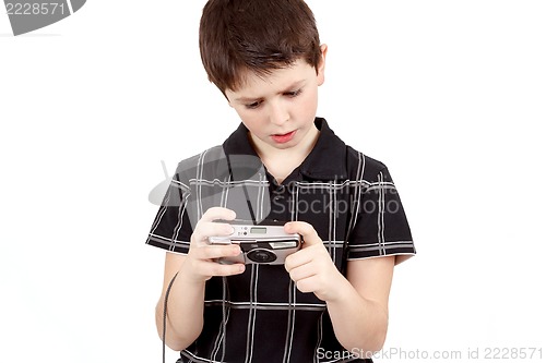 Image of small boy checking analog camera settings