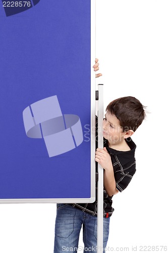 Image of Portrait of happy little boy with blue blank board