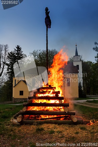 Image of big walpurgis night fire with witch on pile behind the church