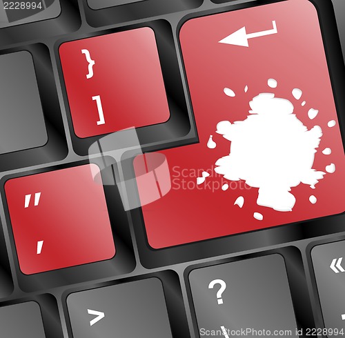 Image of Computer keyboard with red colored enter key and blots