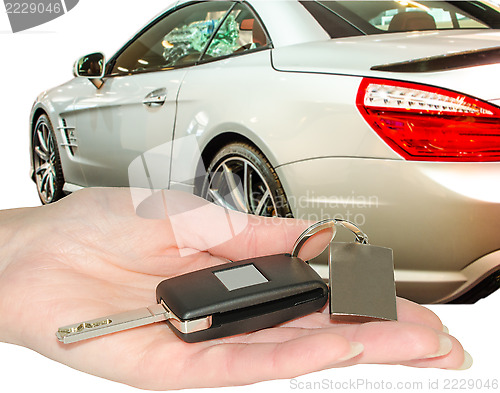 Image of Female hand of new car owner holding auto keys isolated