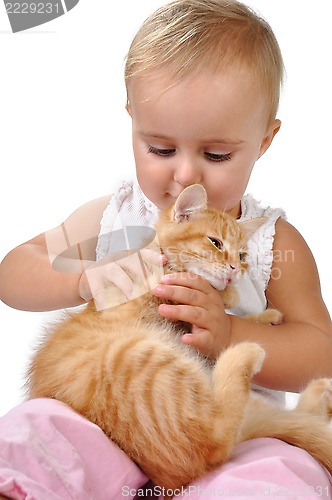 Image of baby child playing with a kitten