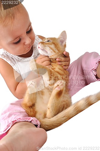 Image of toddler child plays with a cat