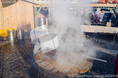 Image of people hot drink wine big pot smoke fair market 