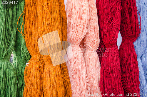 Image of background of various colors wool threads closeup 