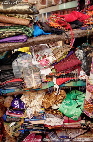 Image of rough stacking of clothing on shelf