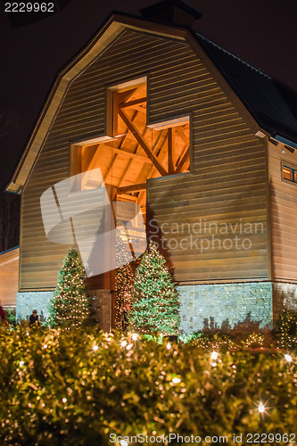 Image of architectural cross at a village decorated for christmas time