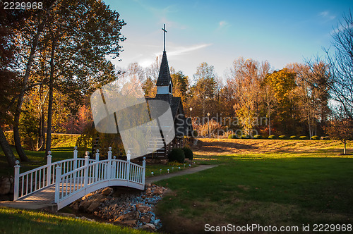 Image of small chapel across the bridge in fall