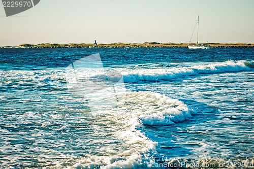 Image of ocean waves and yaht in the sea