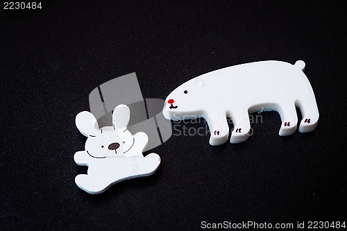 Image of Close up white animal magnets on dark background