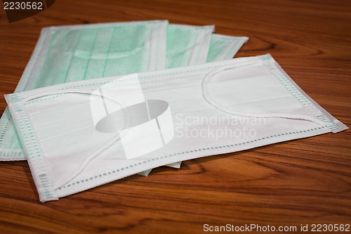 Image of New medical green mask on wood background