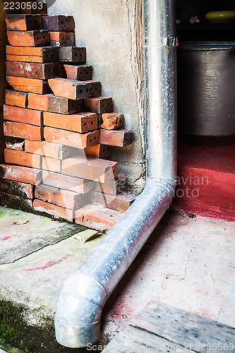 Image of Old rain gutter with drainpipe inside  residence