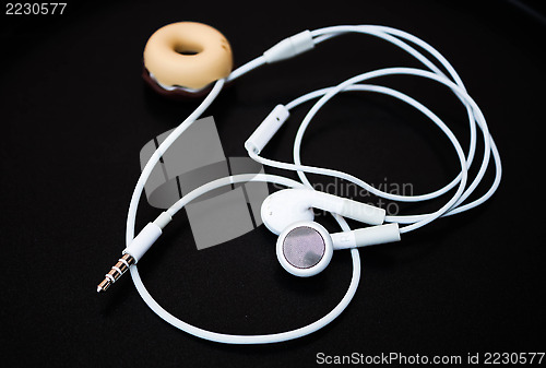 Image of White ear buds and line store isolated on dark background