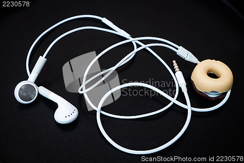 Image of White earphones with line store isolated on dark background