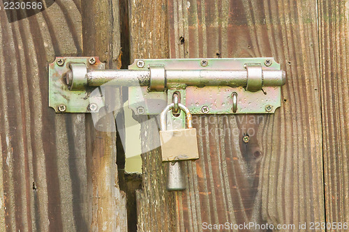 Image of Wrought iron lock old wooden door