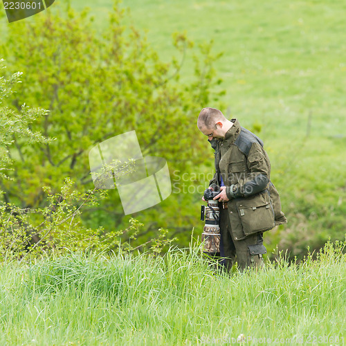 Image of Wildlife photographer with long telephoto