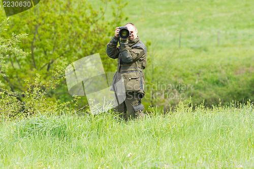 Image of Wildlife photographer with long telephoto