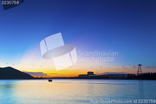 Image of Sunset in Hong Kong along seashore and mountains