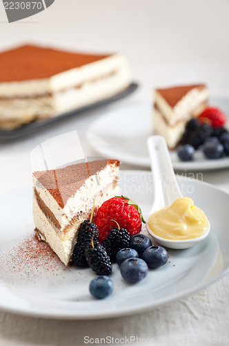 Image of tiramisu dessert with berries and cream