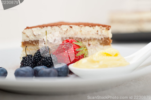 Image of tiramisu dessert with berries and cream