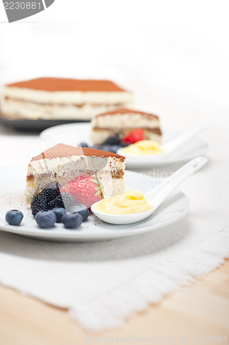 Image of tiramisu dessert with berries and cream