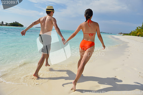 Image of happy young couple have fun on beach