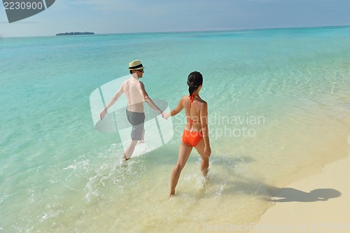 Image of happy young couple have fun on beach