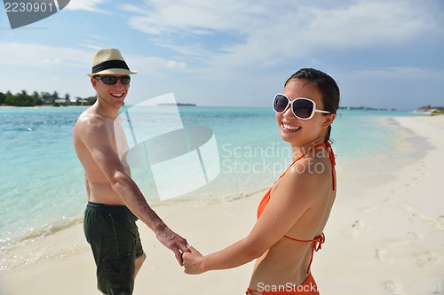 Image of happy young couple have fun on beach
